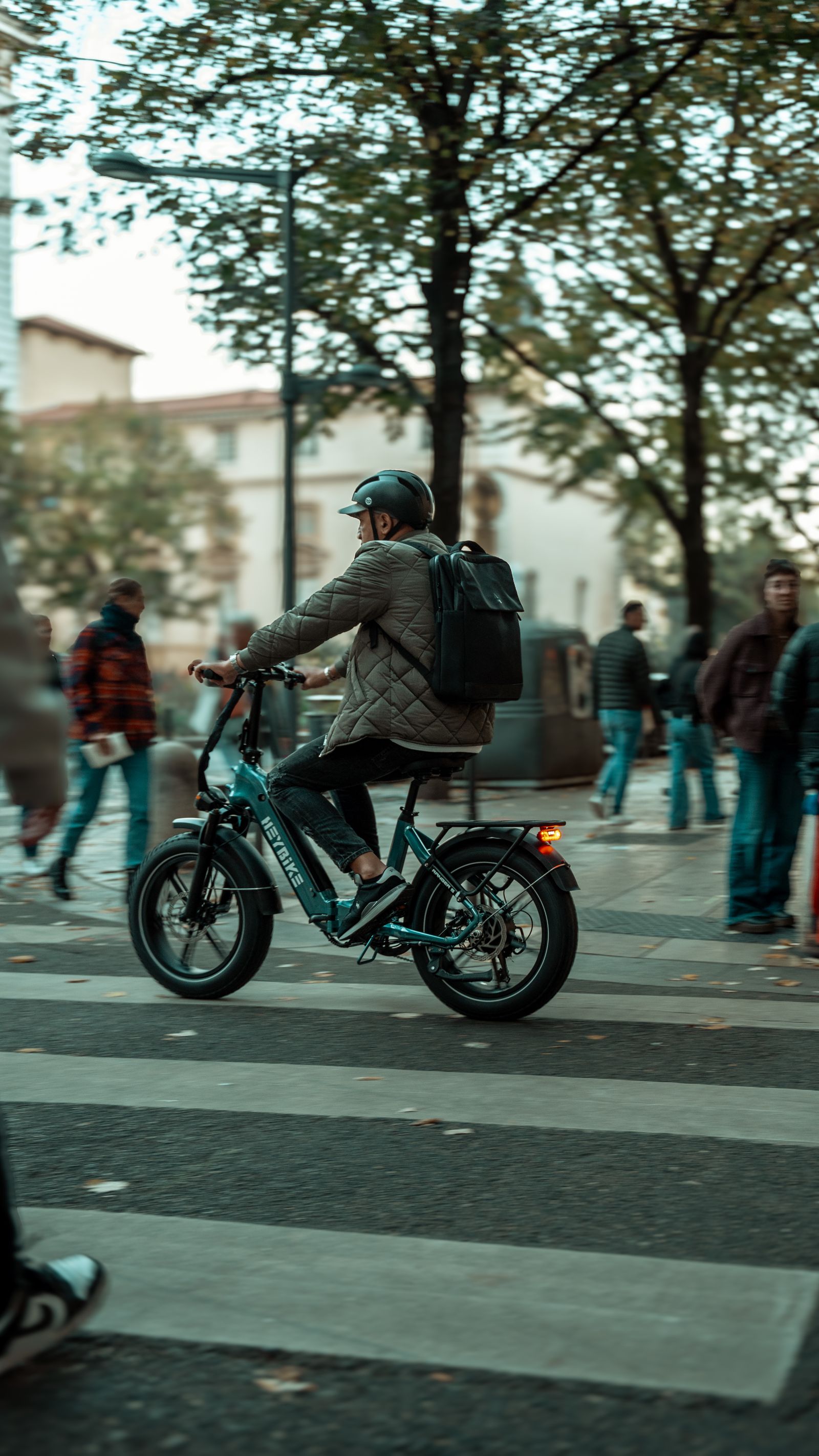 E-bike commuting past city traffic